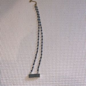 Gray beaded necklace with shiny stone. Gold chain.